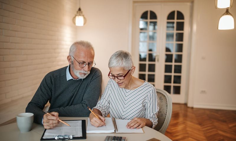 Elderly couple reviewing the pros of joining a credit union