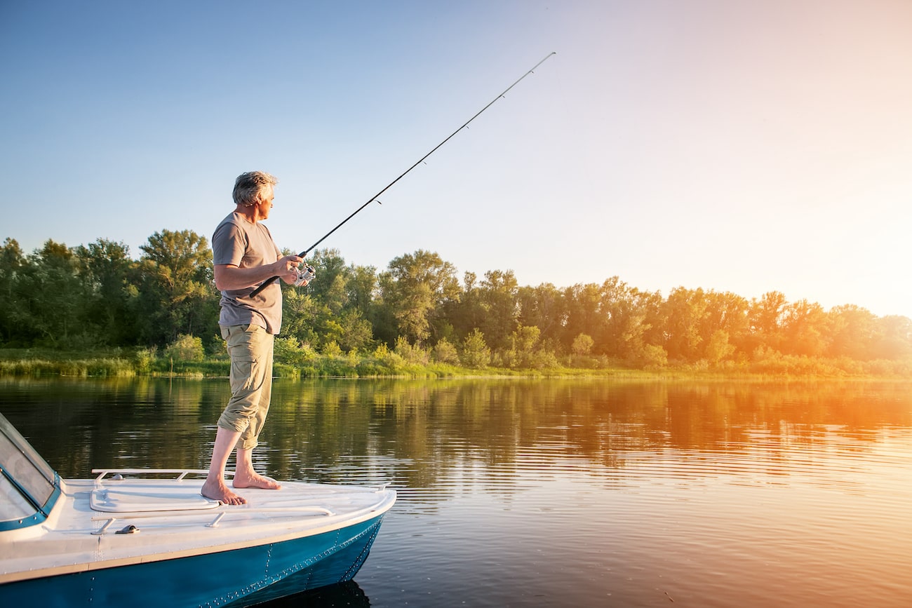 Man fishing off the front of a boat