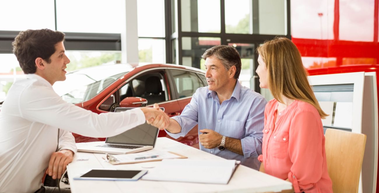 Shaking hands at car dealership