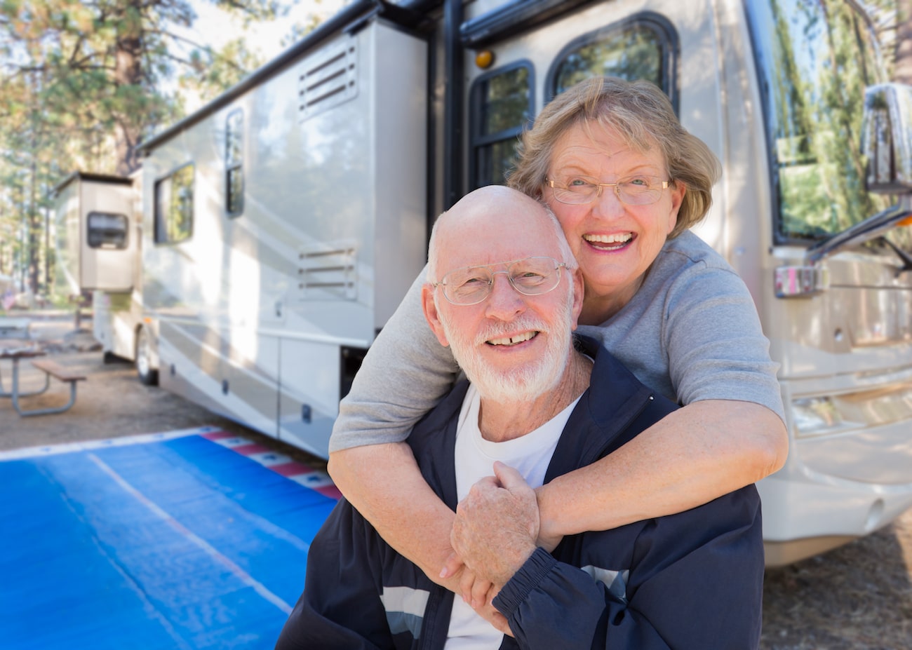 Smiling couple in front of recreational vehicle